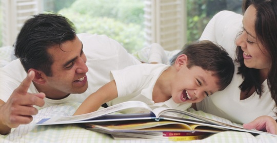 Parents Reading to Laughing Boy